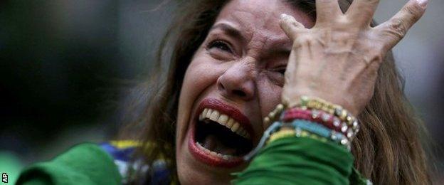 A Brazil soccer fan cries as Germany scores against her team at a semifinal World Cup match as she watches the game on a live telecast in Belo Horizonte, Brazil,