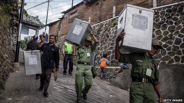 Election officers carry ballot boxes from for distribution to the polling stations during preparations for the presidential election on 8 July 2014 in Yogyakarta