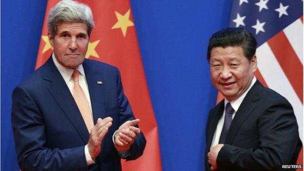 US Secretary of State John Kerry (L) applauds after China's President Xi Jinping gave his speech during the opening ceremony of the Sixth Round of US-China Strategic and Economic Dialogue at Diaoyutai State Guesthouse in Beijing on 9 July 2014.