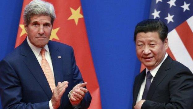 US Secretary of State John Kerry (L) applauds after China's President Xi Jinping gave his speech during the opening ceremony of the Sixth Round of US-China Strategic and Economic Dialogue at Diaoyutai State Guesthouse in Beijing on 9 July 2014.