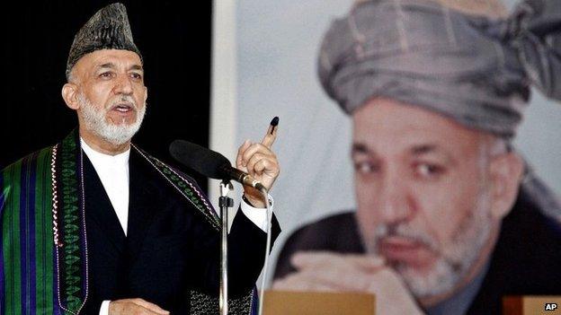 Afghan President Hamid Karzai speaks after casting his vote at a polling station in Kabul, Afghanistan, Saturday, June 14, 2014.