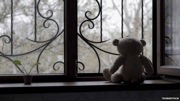 Teddy bear in window