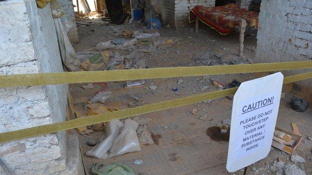 Danger sign in front of entrance to destroyed room in Miranshah