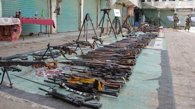 Dozens of guns laid in a line in Miranshah