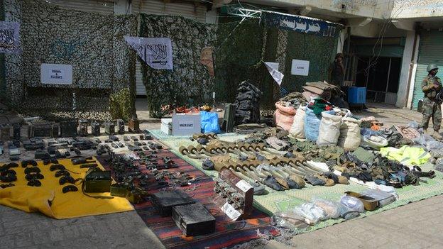 Weapons and ammunition laid out on ground in Miranshah