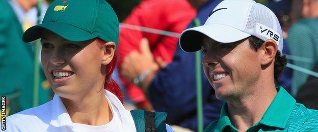 Caroline Wozniacki caddiying for Rory McIlroy at the Masters Preview Day