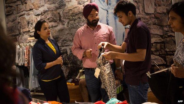 Shoppers browse sale items in a mall in Delhi (6 July)