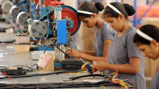 Women at machines in factory working