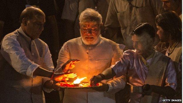 Prime minister, Modi, praying over a flame after election victory