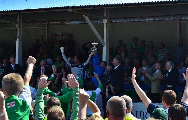 Guernsey goalkeeper Chris Tardif lifts the Muratti trophy in 2013 at The Track