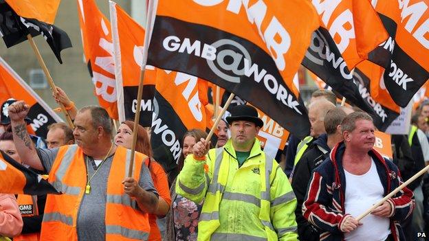 Members of the GMB union make their way through Brighton