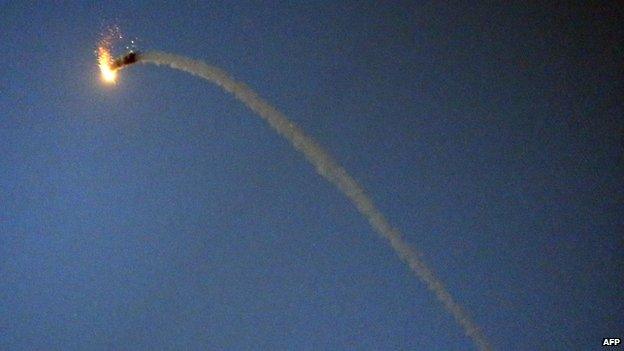 A Palestinian Hamas made M75 missile flies over Gaza City after it was launched towards Israel on 9 July 2014.