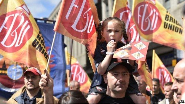 Public sector worker Scott Clarke with six-year-old daughter Amber Clarke during a march through Newcastle city centre.