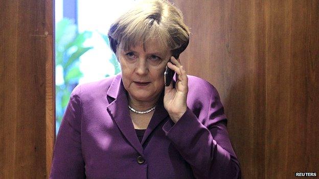 File image of Angela Merkel using mobile phone. 9 Dec 2011