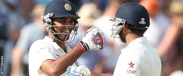 India's Mohammed Shami (L) and India's Bhuvneshwar Kumar celebrate