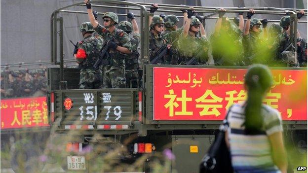 This picture taken on 6 June 2014 shows security forces participating in a military drill in Hetian, northwest China's Xinjiang region.