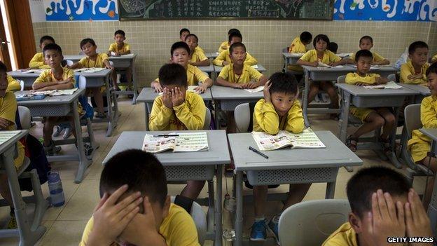 Young Chinese football players attend classes after training at the Evergrande International Football School on 13 June, 2014 near Qingyuan in Guangdong Province, China