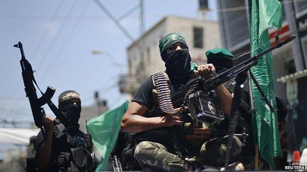 Palestinian members of Hamas armed wing take part in the funeral of their comrades in Gaza City on 21 June 2014