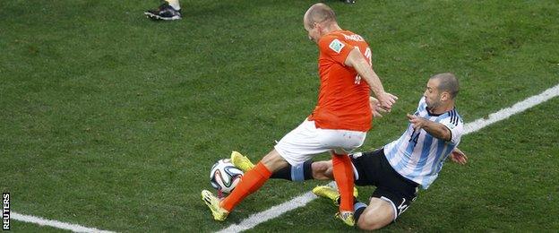 Argentina midfielder Javier Mascherano (right) tackles Netherlands forward Argen Robben