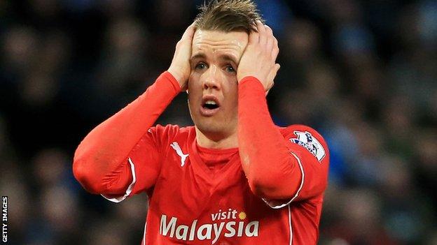 Cardiff City winger Craig Noone holds his head in his hands