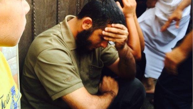 The brother of Hamas fighter Nidal al-Malesh sitting in shock not long after his brother was killed in an Israeli missile strike. Israel says two others involved in rocket fire were killed in same attack. Three others were killed in the attack.