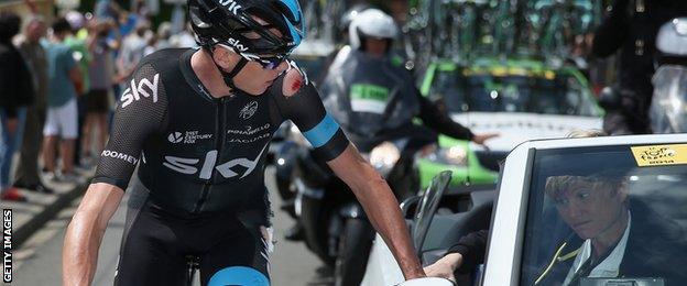 Chris Froome receives treatment after falling off his bike during the 2014 Tour de France