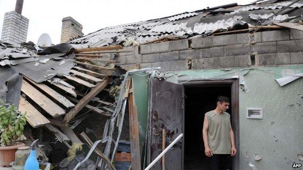 Man in doorway of house in suburb of Donetsk, Ukraine bombed on Friday and Saturday - photo 13 July