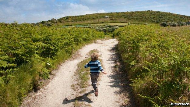 Child running down Cornish track