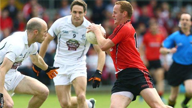 Kildare pair Hugh McGrillen and Gary White close in on Benny Coulter