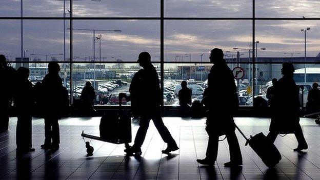 Passengers walking through an airport