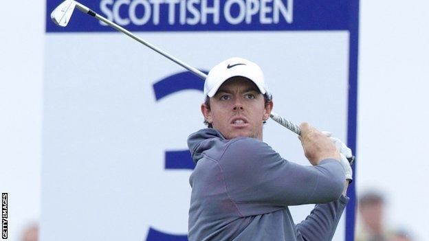 McIlroy watches his tee shot on the third hole on Sunday