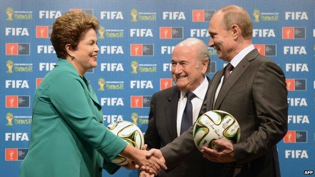 Brazil's President Dilma Rousseff, FIFA President Sepp Blatter and Russia's President Vladimir Putin pose during the handing over of the 2018 FIFA World Cup to Russia