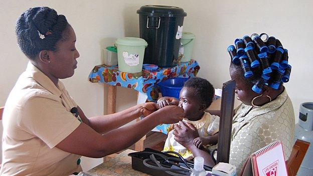 Alice Yamoah-Grant examines a baby