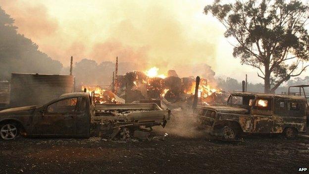 A file photo taken on 7 February 2009 shows vehicles burning near Labertouche, some 125km west of Melbourne