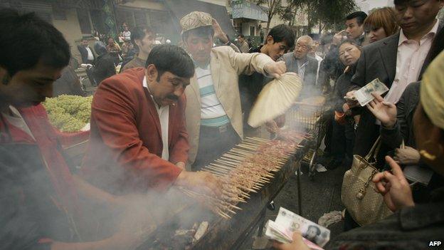 Ethnic Uighur Muslims cook lamb outside the Niujie Mosque in Beijing to celebrate Eid Al-Fitr, the end of Ramadan and month-long fasting on 13 October 2012