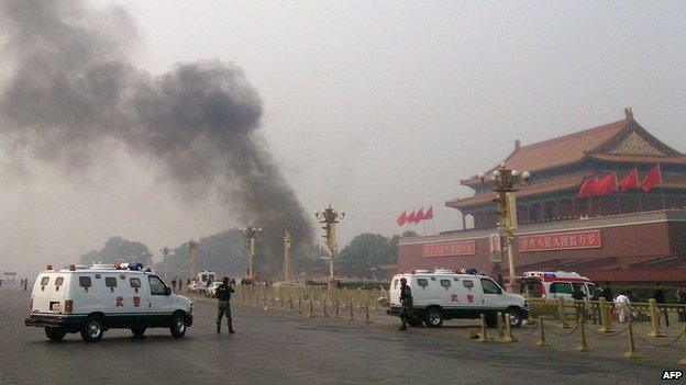 This file photo taken on 28 October, 2013 shows police cars blocking off the roads leading into Tiananmen Square after a vehicle loaded with petrol crashed in front of Tiananmen Gate in Beijing