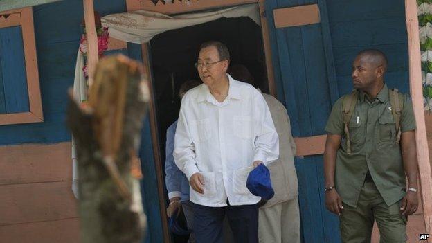 UN Secretary-General Ban Ki-moon walks out after visiting the house of a cholera victim during the launching of sanitation campaign in Hinche, Haiti, Monday, July 14, 2014.