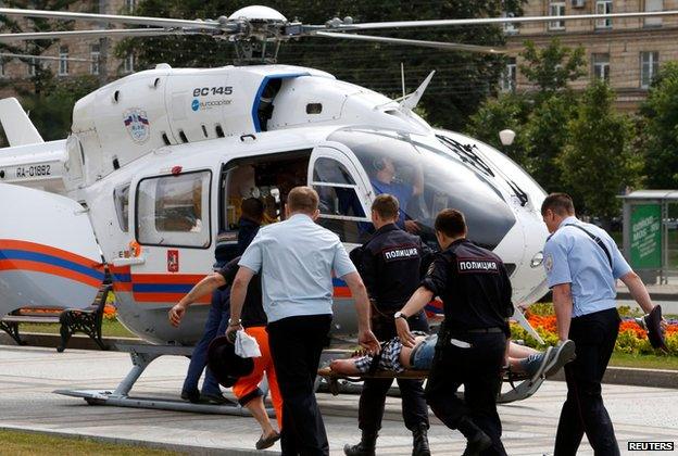 Injured person being taken to helicopter after Moscow metro crash (15 July)