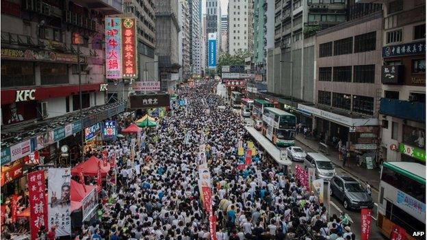 Demonstrators march during a pro-democracy rally seeking greater democracy in Hong Kong on 1 July 2014 as frustration grows over the influence of Beijing on the city.