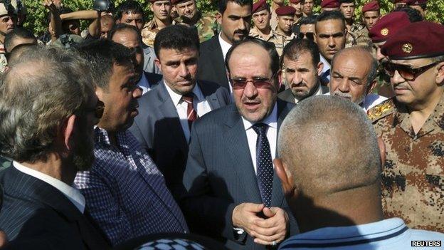 Nouri Maliki attends the funeral of an army commander killed in fighting with Isis-led Sunni rebels in Iraq (7 July 2014)