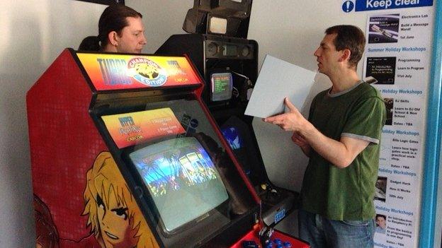 Volunteers working on arcade games