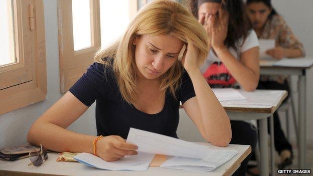 Students take a test in a classroom.
