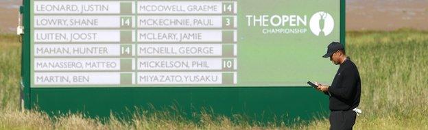 Tiger Woods pictured in front of a scoreboard during a practice round at Hoylake