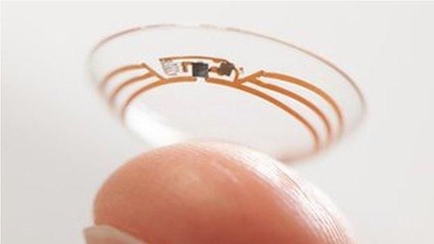 finger holding up Google contact lens prototype