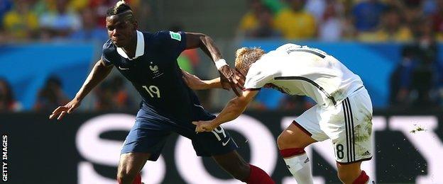 Paul Pogba is challenged by Germany's Toni Kroos