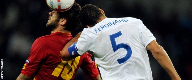 Montenegro's Radomir Djalovic (L) vies for the ball against England's Captain Rio Ferdinand (R) during the Euro 2012 Group G qualifying football match at Wembley Stadium in London in October 2010.