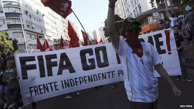 A demonstrator wears an Argentina national team jersey as he gestures during a protest before the World Cup final match between Argentina and Germany in Rio de Janeiro, July 13, 2014.