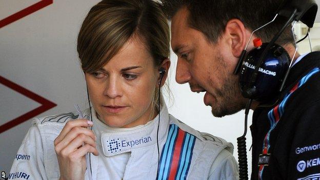 William's Susie Wolff talks to mechanics in the garage before the first practice session at the British Grand Prix