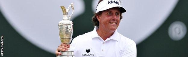 Phil Mickelson holds aloft the claret jug.