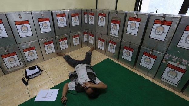 A man takes a rest near ballot boxes at Bendungan Hilir in Jakarta, in this file photo taken on 10 July, 2014